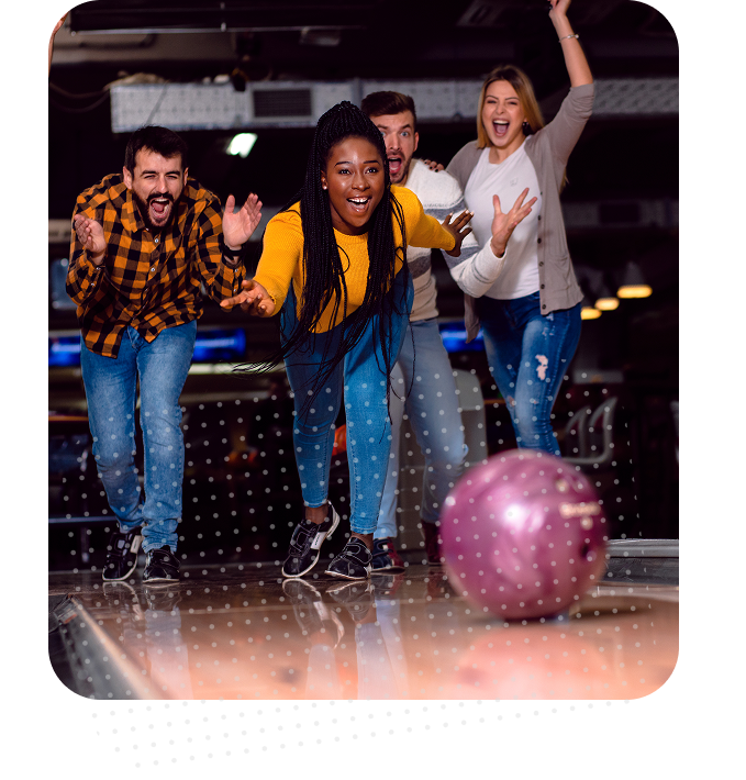 Group of friends cheering and celebrating during a bowling league night