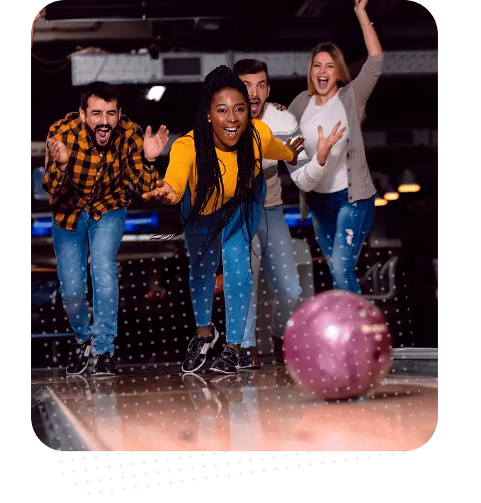 Group of friends cheering and celebrating during a bowling league night