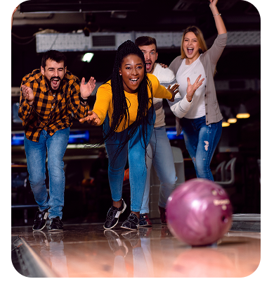 Group of friends cheering and celebrating during a bowling league night