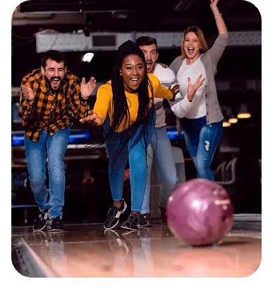 Group of friends cheering and celebrating during a bowling league night