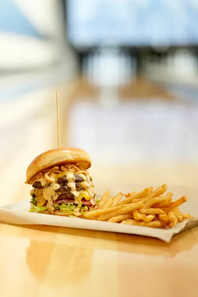 Triple-stacked burger with cheese, onion straws, and chipotle ranch served with crispy fries