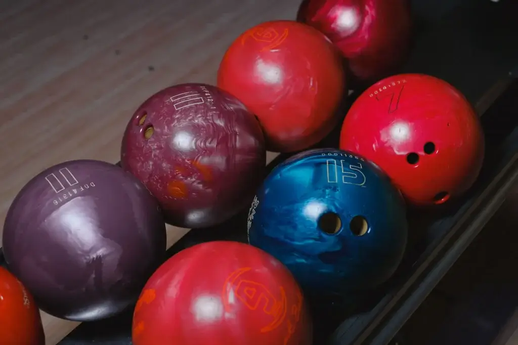 Close-up of red, purple, and blue bowling balls grouped together